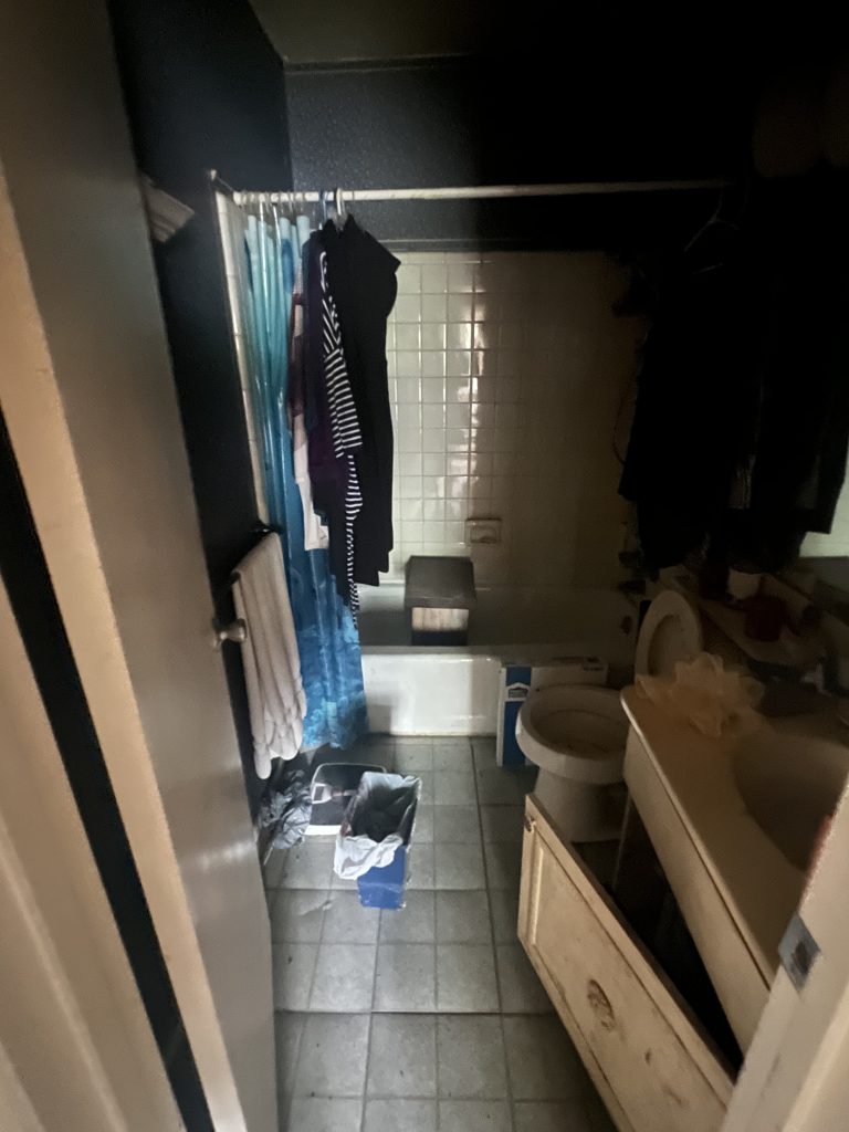 Old hallway bathroom with basic fixtures