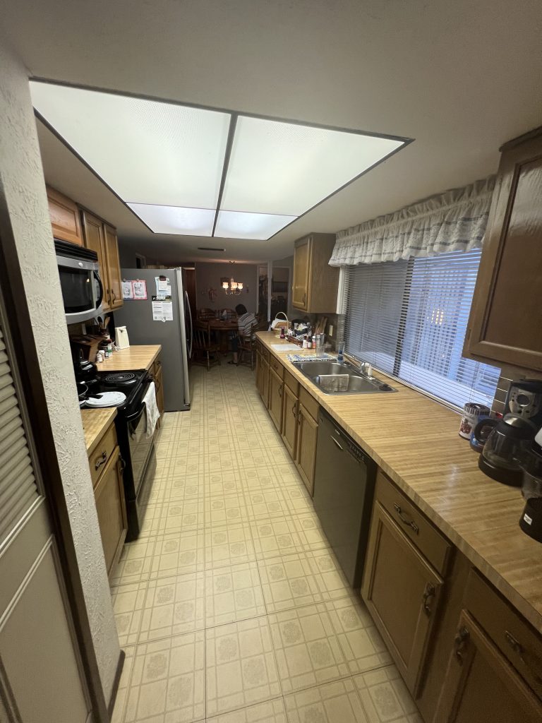 Original kitchen layout with dark cabinets