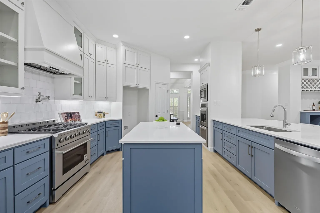 Gourmet kitchen with blue and white cabinets